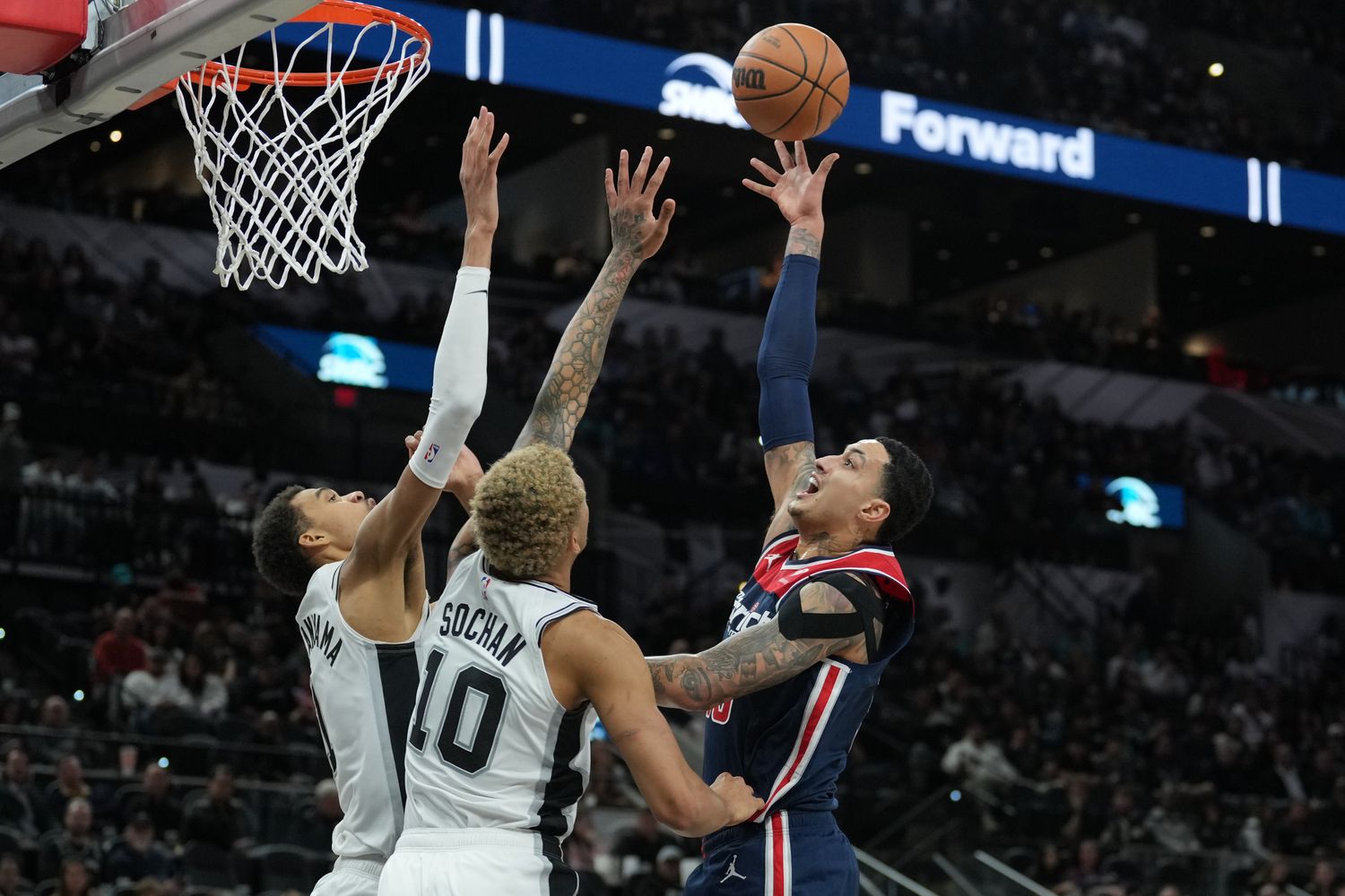 Washington Wizards forward Kyle Kuzma (33) shoots over San Antonio Spurs center Victor Wembanyama (1) and forward Jeremy Sochan (10) in the second half at Frost Bank Center. Mandatory Credit: Daniel Dunn-USA TODAY Sports